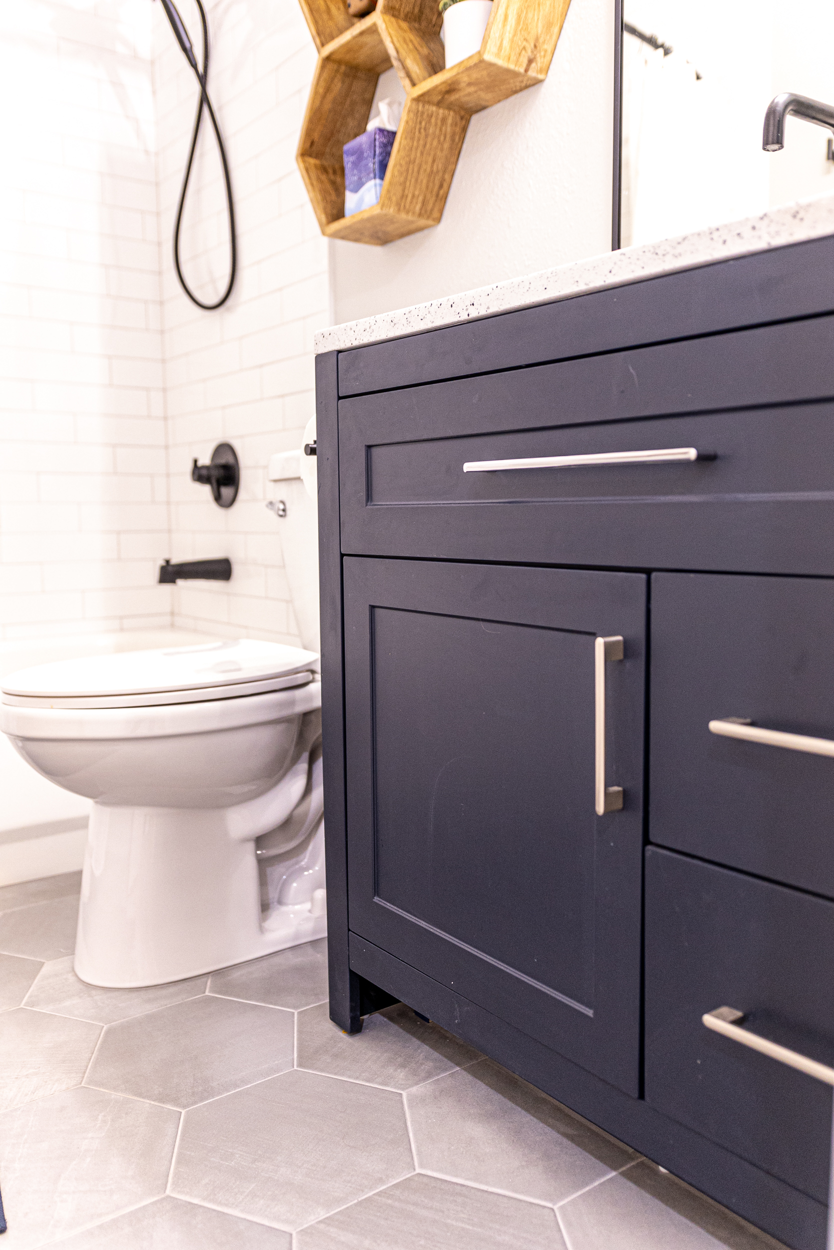Shower with matte black fixtures and subway tile
